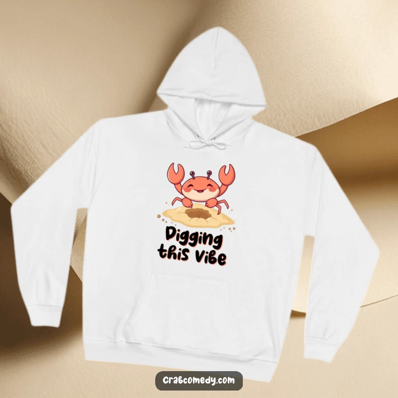 Funny hooded sweatshirt featuring a crab enthusiastically digging a hole in the sand, cozy gift.