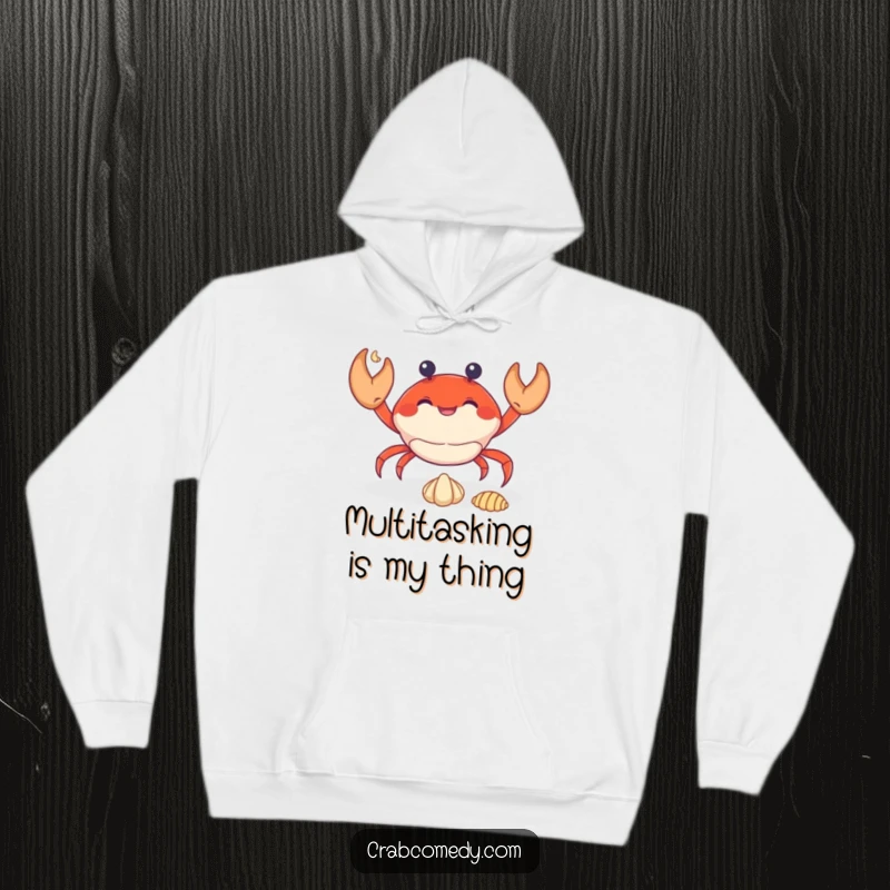 Funny crab skillfully juggling three tiny seashells, printed on a warm and cozy hoodie.