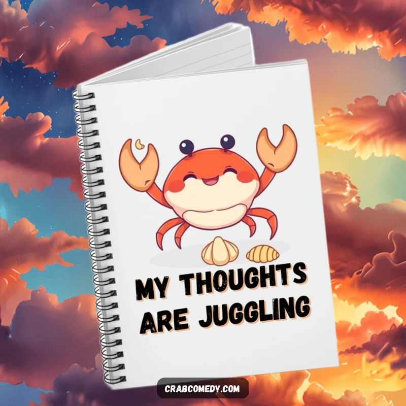 Funny crab juggling three tiny seashells on the cover of a spiral-bound notebook.